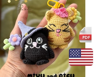 May include: Crocheted cat and kitten keychains. The black cat wears a witch hat, and the yellow kitten has a flower. The keychains are held in a hand. The text "miyu and pifu" is at the bottom of the image.
