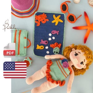 May include: A selection of crochet items with a seaside theme. Includes a doll, sunglasses, a hat, a suitcase, and a placemat with sea creatures. The doll wears a green and orange swimsuit. The items are in various colours, including blue, orange, and pink.