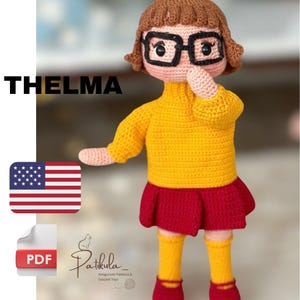 May include: Crochet amigurumi pattern for a doll with brown hair, yellow sweater, red skirt, and yellow socks. The pattern is called "Thelma" and is available as a PDF download.
