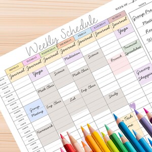 May include: A colorful weekly schedule planner with pastel-colored boxes for each day and time slot. The planner includes sections for journaling, yoga, science, and other activities. A collection of colored pencils is in the foreground.