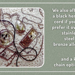 May include: Assorted resin pendants with natural inclusions, including ferns and small stones, displayed on various chains. The image also shows a black hemp cord option and text that says "We also offer a black hemp cord if you'd prefer it over stainless steel or bronze alloy."