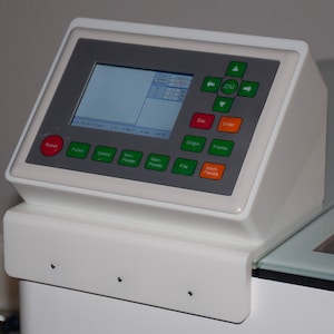 May include: A white control panel with a digital display and buttons labeled "Reset", "Pulse", "Speed", "Min Power", "Max Power", "File", "Start/Pause", "Frame", "Origin", "Esc", "Enter", and "Z/U".