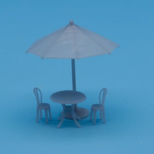 May include: A gray plastic patio set with a round table and two chairs. The set is under a gray umbrella.