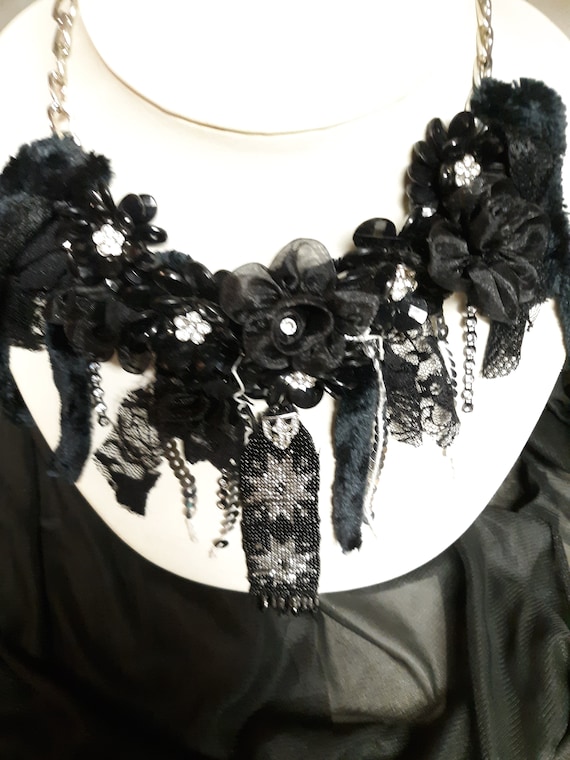 Black Magic makes any simple Black dress elegant and whimsical at the same time. Antique beaded celestial center piece. Great for parties. Black Magic makes any simple Black dress elegant and whimsical at the same time. Antique beaded celestial center piece. Great for parties.