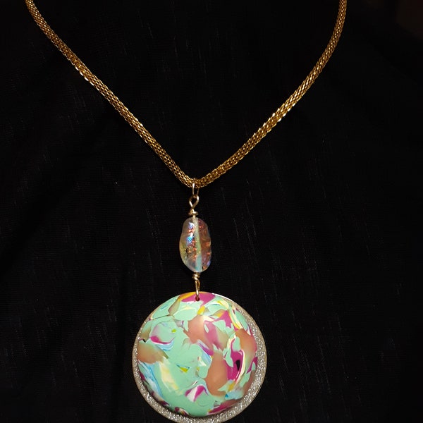 Spring Collection - fimo medallion pared paired with sparkling glitter cover gold colored disc. Extends from a cable chain & iridescent bead