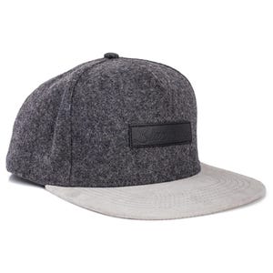 May include: A gray and light gray snapback hat with a flat brim. The hat features a dark gray crown and a light gray brim. A black rectangular patch with the word "Blacklist" is on the front.