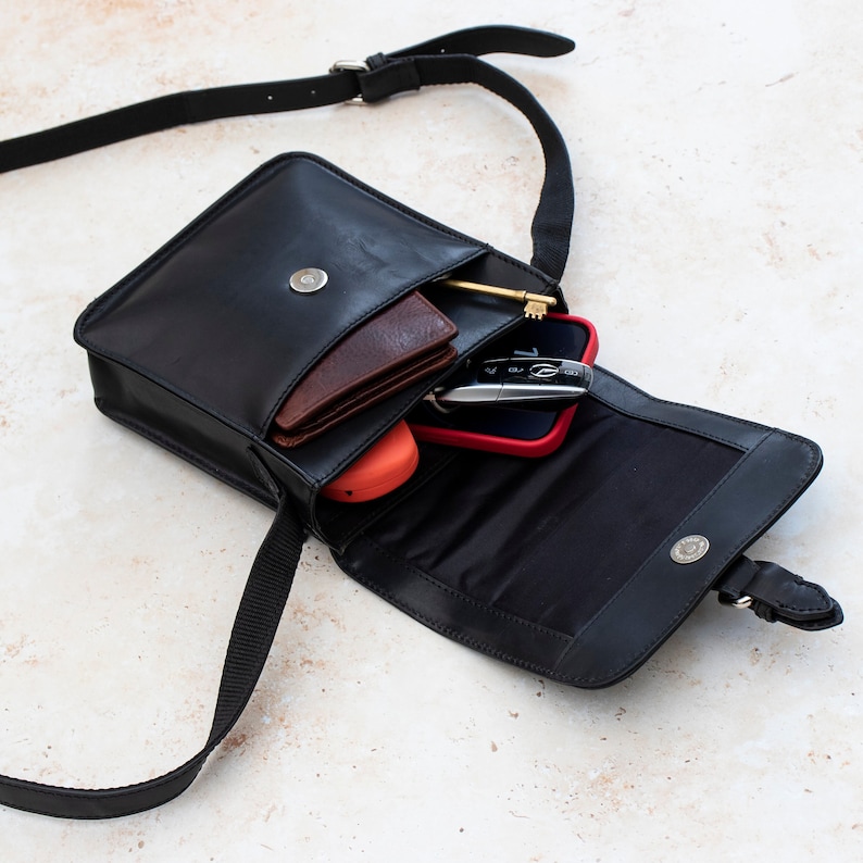 Interior compartments of black leather satchel