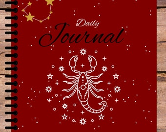 Könnte beinhalten: Rotes tägliches Journal mit einer weißen Skorpion-Illustration und dem Text "Scorpio Daily Journal" sowie dem astrologischen Symbol für Skorpion.
