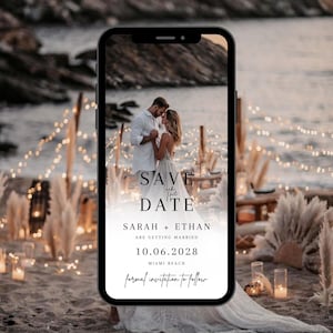 May include: A save the date card featuring a photograph of a couple on a beach. The card reads "Save the Date" in black text against a white background. The couple's names are Sarah and Ethan, and the date is 10.06.2028. The location is Miami Beach. The text "formal invitation to follow" is written in cursive.