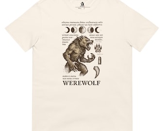 May include: Cream-colored t-shirt featuring a detailed illustration of a werewolf with moon phases, a paw print, a bullet, and a claw. The word "WEREWOLF" is printed below the illustration in a bold font. The shirt has a classic crew neck.