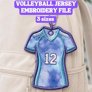 May include: An embroidered volleyball jersey patch featuring a light blue and purple tie-dye pattern with the number 12 in white. The patch has a dark purple border and a small loop at the top. Text reads: VOLLEYBALL JERSEY EMBROIDERY FILE, 3 sizes, PES, VP3, JEF, DST, HUS, VIP, CSD, XXX FILES.