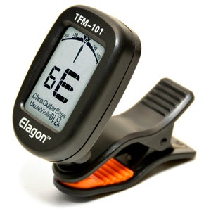May include: Black and orange clip-on digital tuner with a large digital display showing the note "E" and a needle gauge showing the tuning accuracy. The tuner is labelled "TFM-101" and "Elagon" and indicates it can tune Chromatic, Guitar, Bass, Ukulele, and Violin.