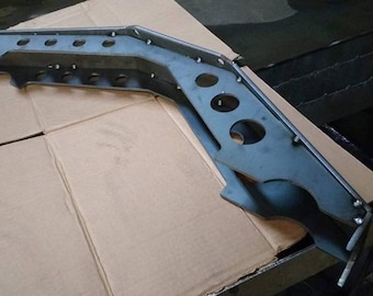 May include: A metal bracket with multiple holes, likely for mounting or attaching other components. The bracket is made of a light gray metal and has a curved shape.