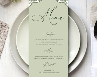 Puede incluir: Una tarjeta de menú con fondo verde salvia y borde decorativo de hojas. La palabra "Menú" está escrita en elegante escritura. El menú enumera aperitivos, platos principales y postres, incluyendo crema brulee y tarta de manzana.
