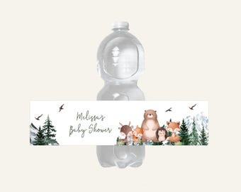 May include: A water bottle with a decorative label featuring woodland animals and the text "Melissa's Baby Shower." The label includes illustrations of a bear, fox, deer, and hedgehog, with trees and mountains.