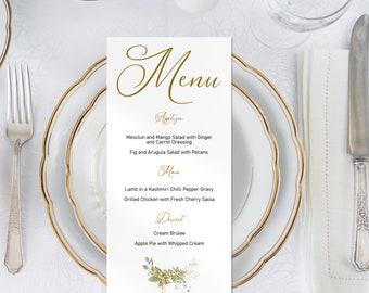 Puede incluir: Una tarjeta de menú blanca con letras doradas y un diseño floral. El menú incluye aperitivos, platos principales y postres. Los aperitivos son ensalada de mesclun y mango con jengibre y aderezo de zanahoria y ensalada de higos y rúcula con nueces. Los platos principales son cordero en salsa de chile Kashmiri y pollo asado con salsa de cereza fresca. Los postres son crema brûlée y pastel de manzana con crema batida.