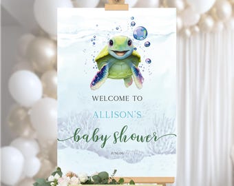 May include: A rectangular welcome sign for a baby shower featuring a cartoon sea turtle swimming among bubbles. The text reads WELCOME TO ALLISON'S baby shower JUNL.06. The design has a light blue watercolor background with coral reef illustrations.