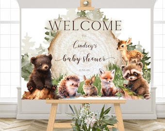 May include: Welcome to Lindsey's baby shower sign with a woodland theme. The sign features a brown bear, a fox, a raccoon, a hedgehog, a rabbit, and a deer on a white background with green foliage.