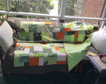 Green and orange throw quilt