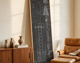 May include: A framed black and white blueprint of a Falcon 9 rocket. The diagram includes detailed schematics of the rocket's components, with the text "Falcon 9" at the top. The artwork is displayed in a room with a wooden cabinet and leather chair.