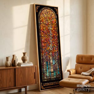 May include: A tall, rectangular stained glass panel in a wooden frame featuring a forest scene with autumn-colored leaves in shades of orange, red, and yellow, and blue tree trunks. The text L'ANCESTRAL LE SOUFFLE DE L'ORIGINE is at the bottom.