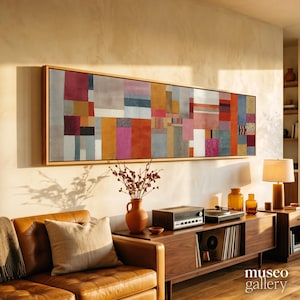 May include: A long rectangular wall art piece featuring a patchwork of vertical and horizontal color blocks in shades of red, orange, yellow, blue, gray, and white, framed in light wood. The text "museo gallery" appears in the bottom right corner.