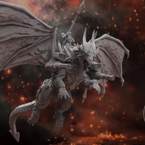 May include: A gray, detailed, 3D printed model of a dragon with wings spread, riding a human figure. The dragon has a long tail and a large head with a sharp snout. The human figure is holding a spear. The model is set against a dark background with a red and orange glow.