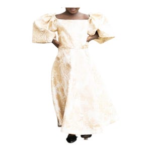 May include: A cream-colored formal dress with a square neckline and puffed sleeves. The dress features a floral pattern in a lighter shade of cream. The skirt is floor-length, and the dress appears to be made of a textured fabric.