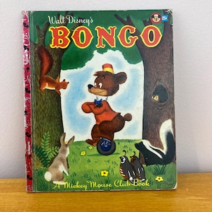 May include: Vintage Walt Disney's "Bongo" book. The cover features a brown bear on a unicycle, surrounded by forest animals. The title is in large red and yellow letters. A Mickey Mouse Club Book.
