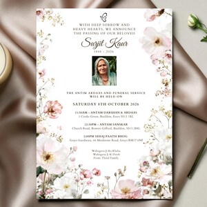 May include: A memorial card with floral accents and the text "Surjit Kaur 1948-2026". The card includes a photograph and details for a funeral service. A lit candle and a flower stem are in the background.