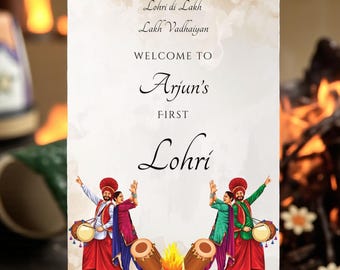 May include: A sign on a wooden easel with the text "Welcome to Arjun's First Lohri." The sign features illustrations of people in traditional attire, drums, and a bonfire. The background includes a blurred image of a bonfire.