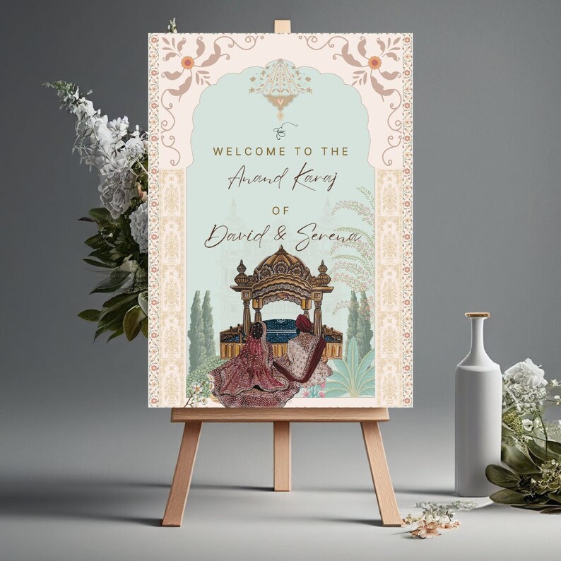 May include: A wedding welcome sign on a wooden easel. The sign features ornate floral and architectural designs in soft pastel colors. Text reads "Welcome to the Anand Karaj of David & Serena."