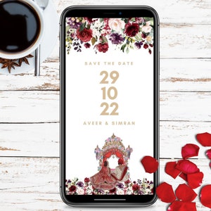 May include: A digital save the date card with a floral design in shades of red, pink, and purple. The text reads "Save the Date 29 10 22 Aveer & Simran". The image also features a traditional Indian wedding ceremony scene.