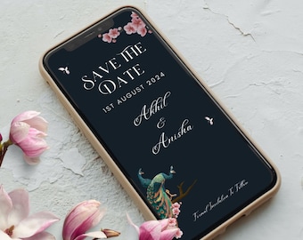May include: A save the date card with a dark blue background, pink flowers, and a peacock design. The text reads "Save the Date" with the date "1st August 2024" and the names "Akhil & Anisha".