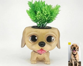 May include: A ceramic planter shaped like a dog with big eyes and a tongue sticking out. The planter is filled with a green succulent plant.