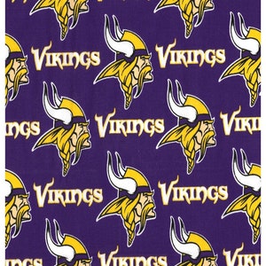 May include: Purple fabric with a repeating pattern of yellow Viking helmets and the word "Vikings" in a gold script font.