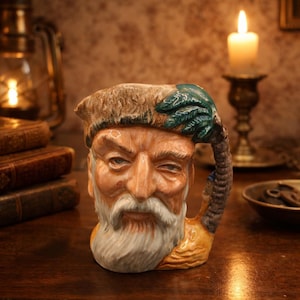 May include: A set of three ceramic mugs with a speckled, matte finish. The mugs are in shades of cream, light gray, and dark gray. Each mug has a simple, minimalist design, perfect for coffee or tea.