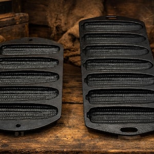 May include: A white ceramic mug with a black handle and the text "But First, Coffee" in a black, handwritten-style font. The mug is on a white surface.