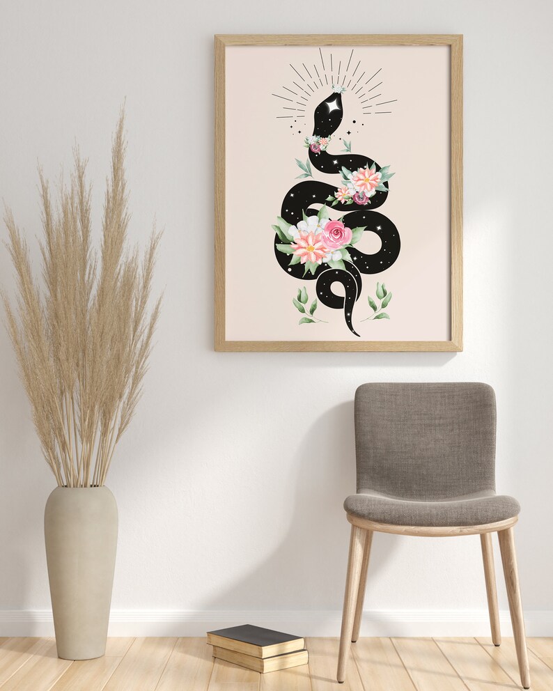 May include: A black snake with a starry pattern is coiled around a bouquet of pink and white flowers. The snake is surrounded by a circle of small stars and a sunburst design. The background is a light peach color.