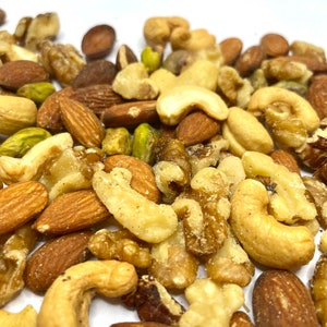May include: A mix of nuts and seeds, including almonds, cashews, walnuts, and pistachios. The nuts are roasted and salted, and some have a light brown glaze.