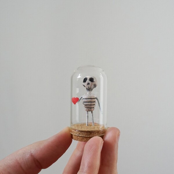small skeleton in a glass case