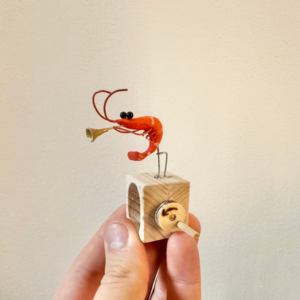 Camarón trompetista, autómata de madera