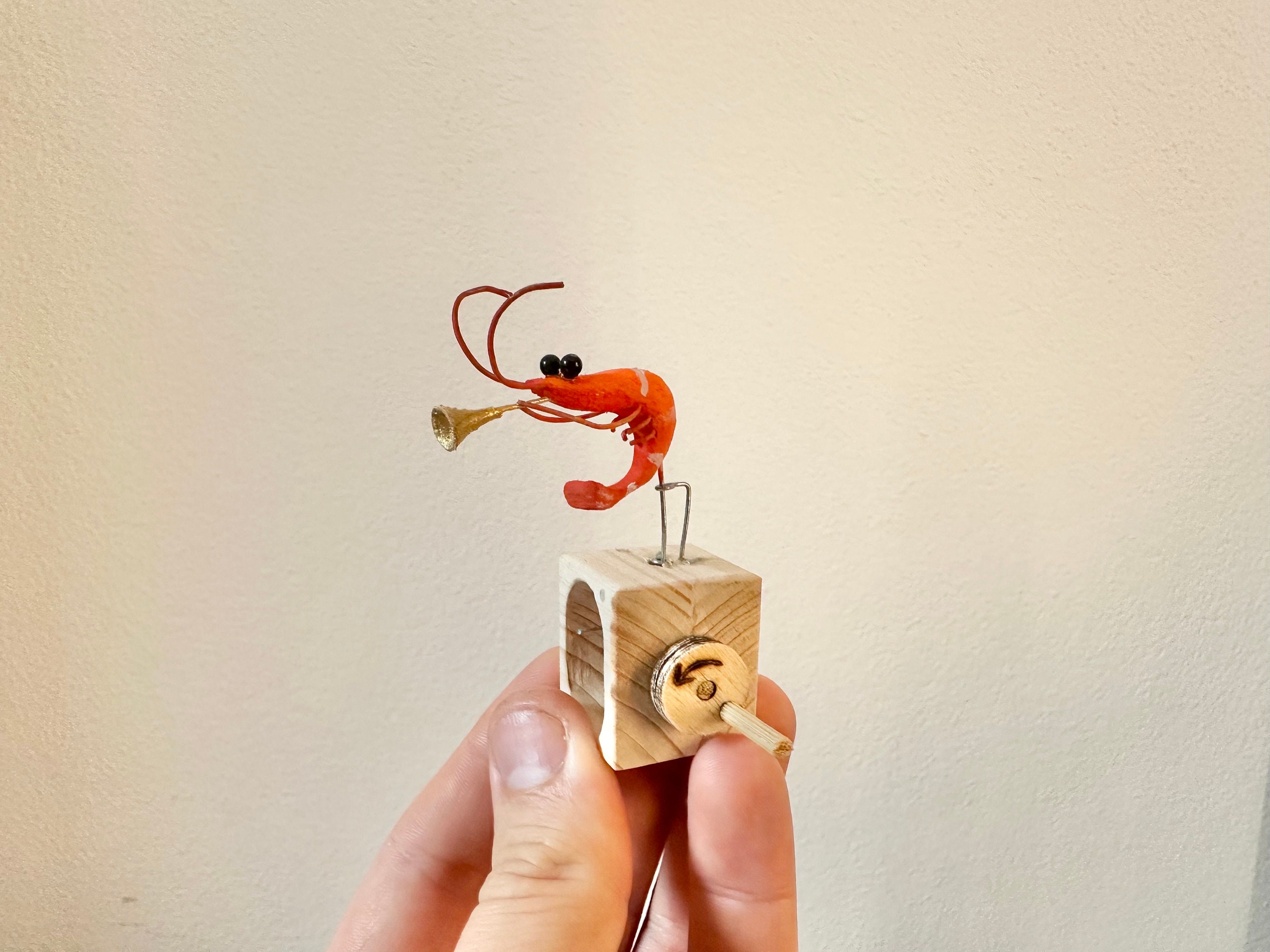 shrimp playing the trumpet, wooden automaton