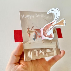 Gamberetto che suona la tromba - biglietto di auguri che si muove semplice da fare