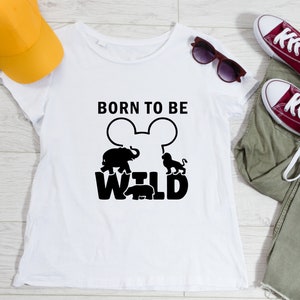 May include: White t-shirt with a black graphic design that says "Born to be Wild" with a Mickey Mouse silhouette and animal silhouettes.