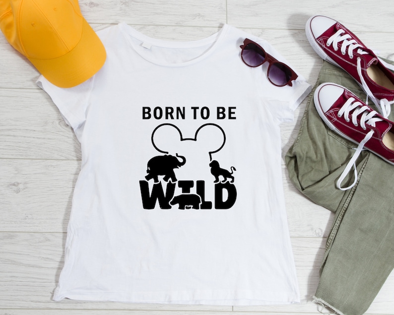 May include: White t-shirt with a black graphic design that says "Born to be Wild" with a Mickey Mouse silhouette and animal silhouettes.