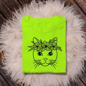 May include: A neon green t-shirt with a black line drawing of a cat wearing a flower crown.