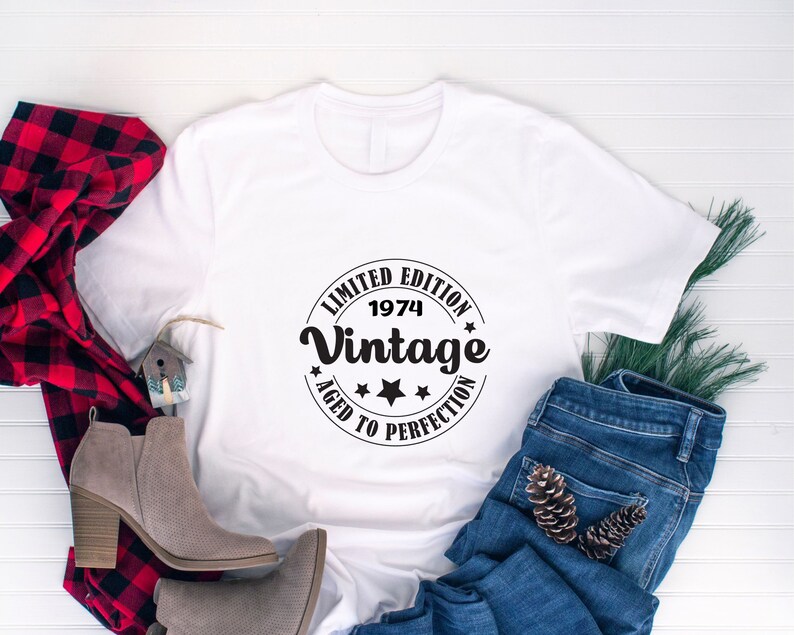 May include: White t-shirt with a black circle graphic that says "Limited Edition 1974 Vintage Aged to Perfection".