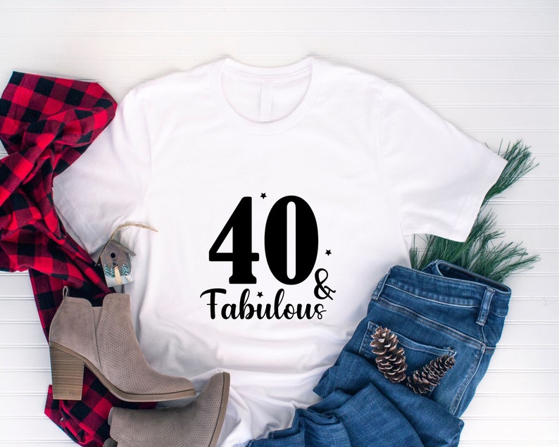 May include: White t-shirt with black text that says "40 & Fabulous".