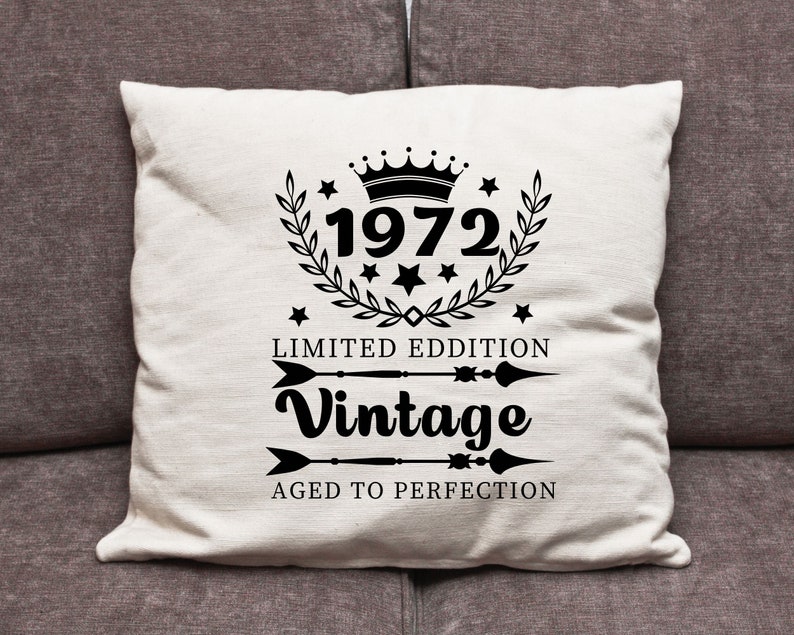 May include: Cream-colored throw pillow with black text and graphics. The design includes the year "1972" inside a laurel wreath, the words "Limited Edition" and "Vintage", and the phrase "Aged to Perfection".